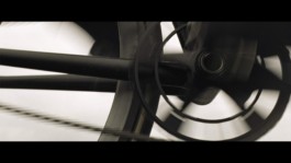 Patrick Seabase riding his track bike on the scenic autumn mountain road of Derborence in Switzerland, surrounded by towering peaks 